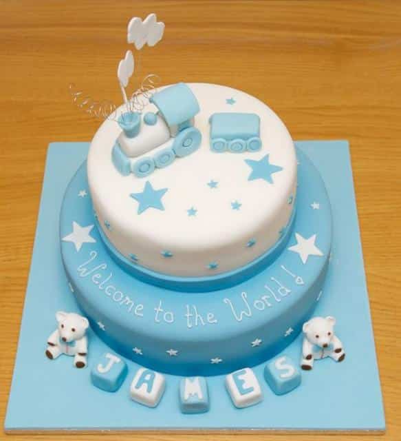 Two tier baby shower cake for boy with train and baby blocks