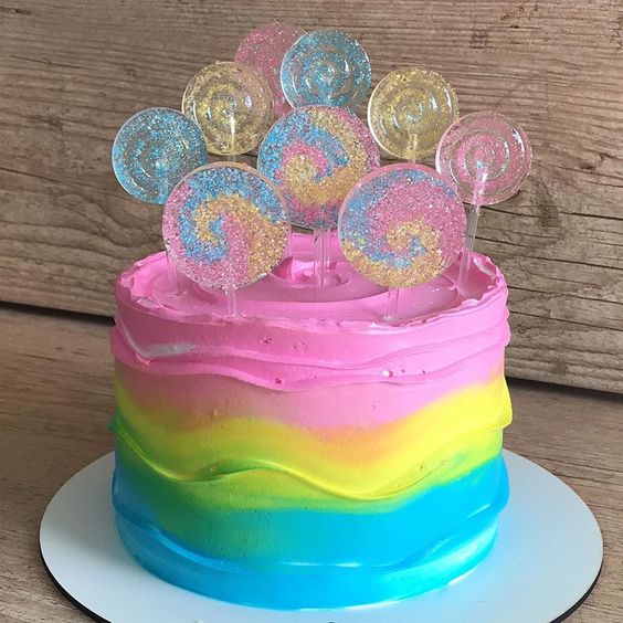 Cakes by Design - Absolutely adored creating this Tie Dye drip cake. I  heard it was everything the birthday girl ever wanted. Complimented with  matching buttercream swirls and mini Macarons. Edible Wrap